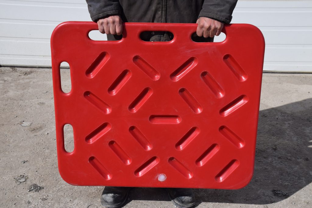 man holding a red hog sorting board